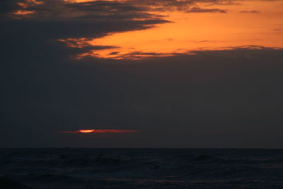 Scenic view of sea against romantic sky at sunset