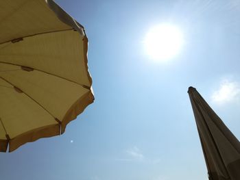 Low angle view of umbrella against sky on sunny day