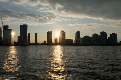 City at waterfront during sunset