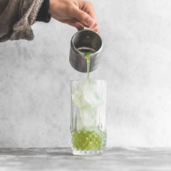 Midsection of man pouring water in glass