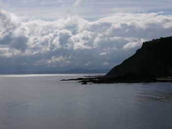 Scenic view of sea against cloudy sky