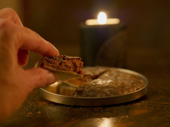 Close-up of hand holding cake