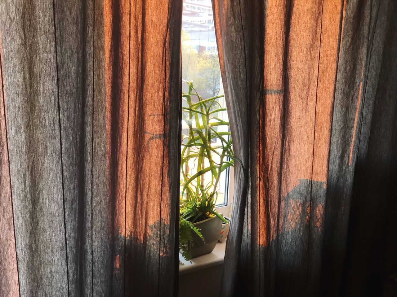 CLOSE-UP OF CURTAIN HANGING ON WINDOW