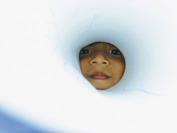 Close-up portrait of boy peeking