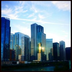 Buildings in city against cloudy sky