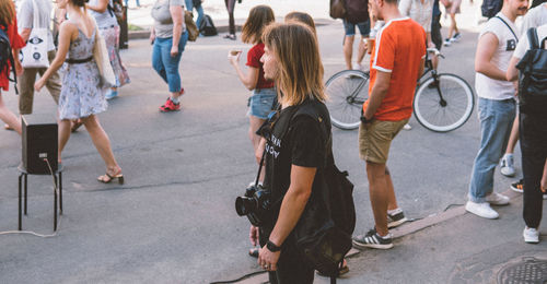 Group of people walking on road in city