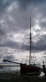 Sailboats moored in sea against sky