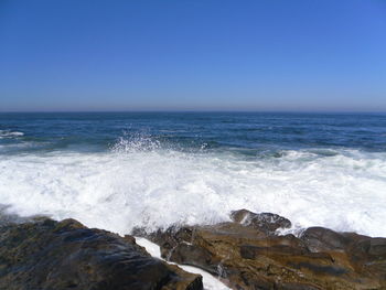 Scenic view of sea against clear blue sky