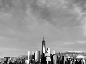 Modern buildings in city against cloudy sky