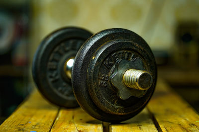 Close-up of old machine part on table