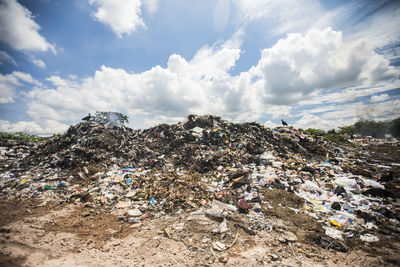 General view of rubbish piled on a landfill full of trash, burning.