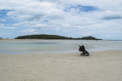 Man on beach against sky