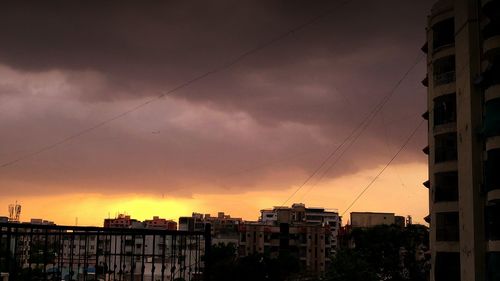 Silhouette cityscape against sky during sunset