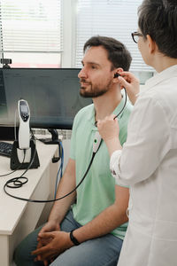 Doctor examining patient in clinic