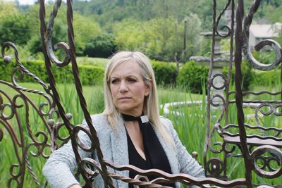 Portrait of woman sitting on plants