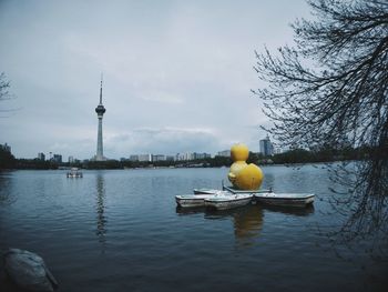 Yellow floating on water against cloudy sky