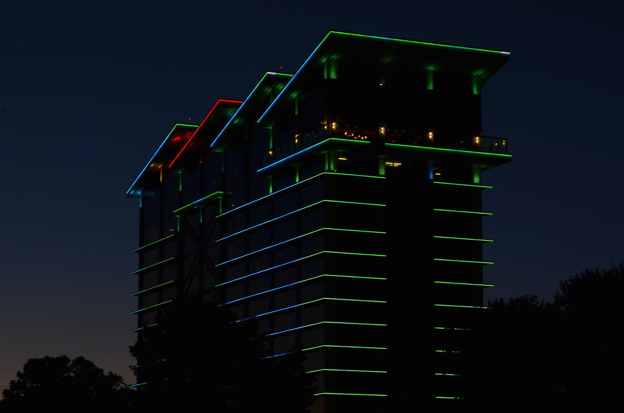 LOW ANGLE VIEW OF ILLUMINATED BUILDING AGAINST CLEAR SKY