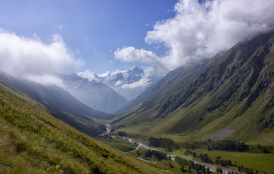 Scenic view of mountains against cloudy sky