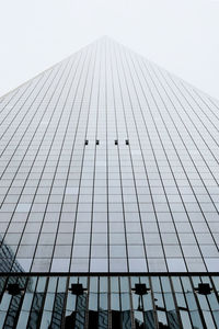 Low angle view of modern skyscraper against sky
