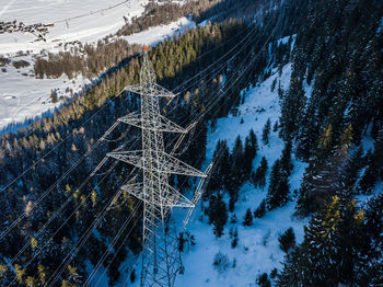 High angle view electrical pylon on snow covered land