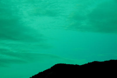 Scenic view of mountains against blue sky