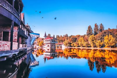 Reflection of buildings in lake against sky