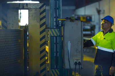 Engineer in industrial plant inspecting machines