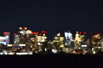 Defocused image of illuminated city at night