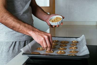 Young man making cookies at the kitchen