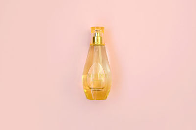 Low angle view of glass bottle on wall