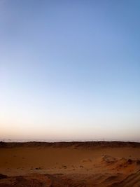 Scenic view of desert against clear blue sky