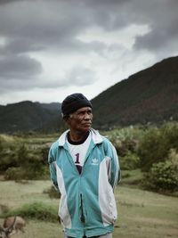 Man standing on mountain against sky