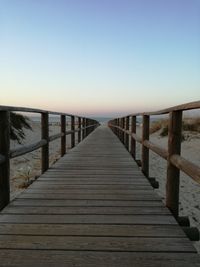 Pier on sea against clear sky