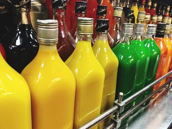 Close-up of multi colored bottles on display at store