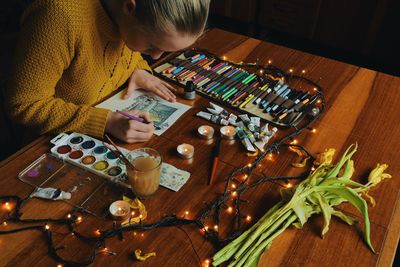 Woman painting on paper at design studio