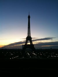 Silhouette of communications tower in city