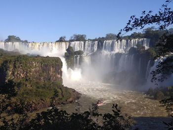 Panoramic view of waterfall against clear sky