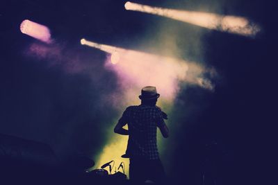 Rear view of man singing in music concert