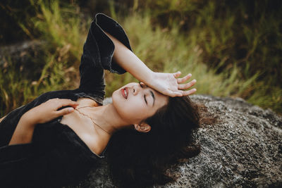 Young woman lying down on land