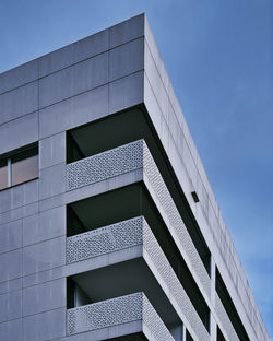 Low angle view of modern building against clear blue sky