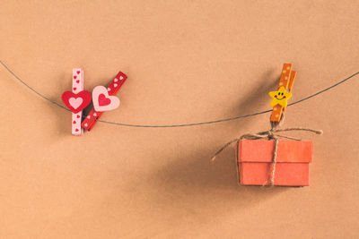 Close-up of red toy tied over white background