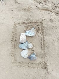 High angle view of footprints on sand