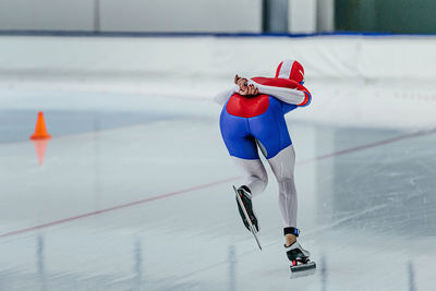 Female athlete speed skater run in ice skating competition