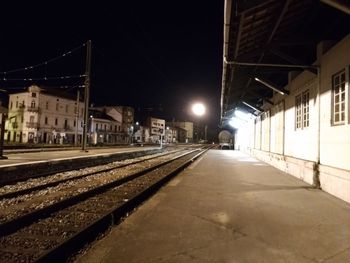 Illuminated railroad station platform at night