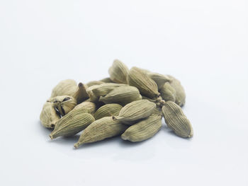 Close-up of cardamoms against white background