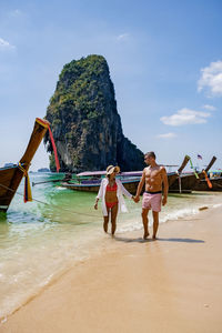 People on beach against sky