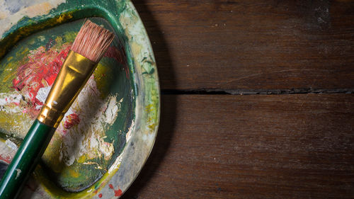 Close-up of paintbrush and palette on table