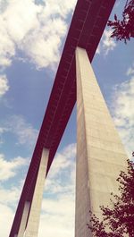 Low angle view of bridge against cloudy sky