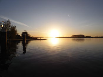 Scenic view of lake at sunset