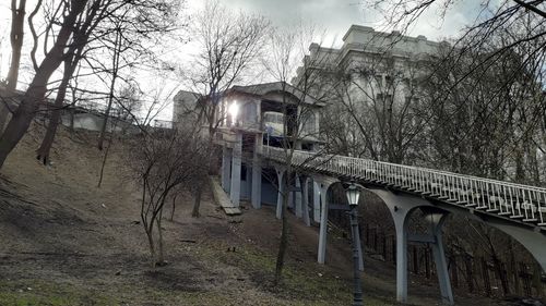 Arch bridge over river amidst buildings in city